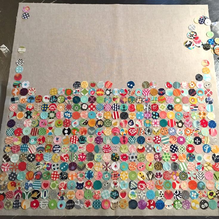 a large piece of fabric covered in lots of different colored buttons