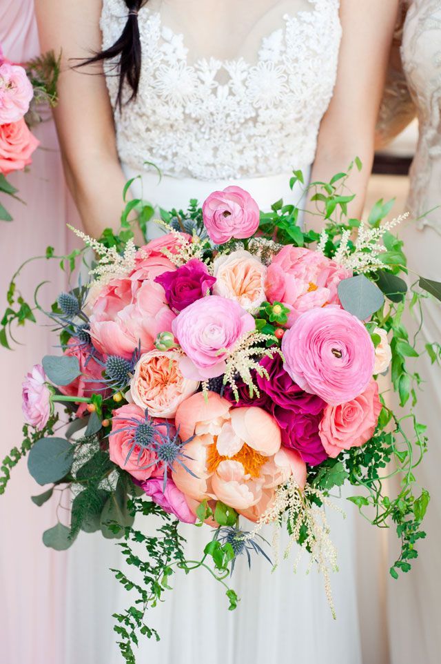 the bridesmaids are holding their bouquets with pink and orange flowers