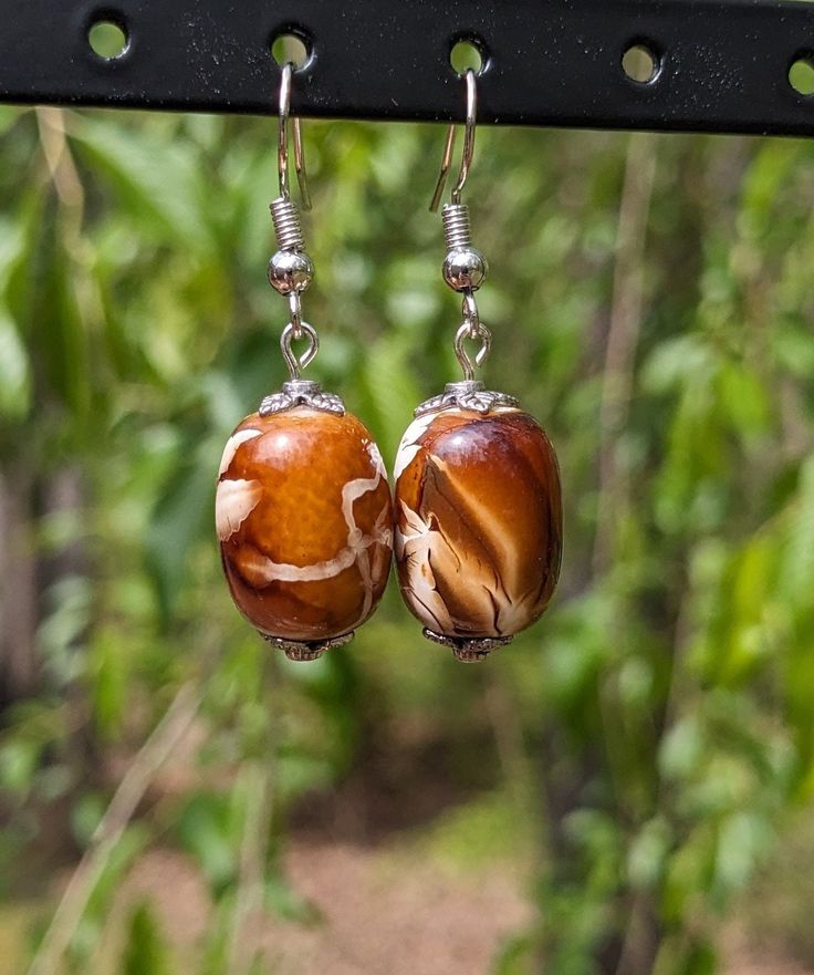 Handmade beaded earrings. Materials sourced locally and upcycled. One in stock. Brown Czech Glass Bead Earrings, Brown Czech Glass Beaded Drop Earrings, Handmade Brown Teardrop Beaded Earrings, Beaded Brown Czech Glass Earrings, Brown Beaded Czech Glass Earrings, Adjustable Brown Earrings With Colorful Beads, Brown Czech Glass Earrings With Dangling Beads, Artisan Czech Glass Beaded Round Earrings, Artisan Czech Glass Round Bead Earrings