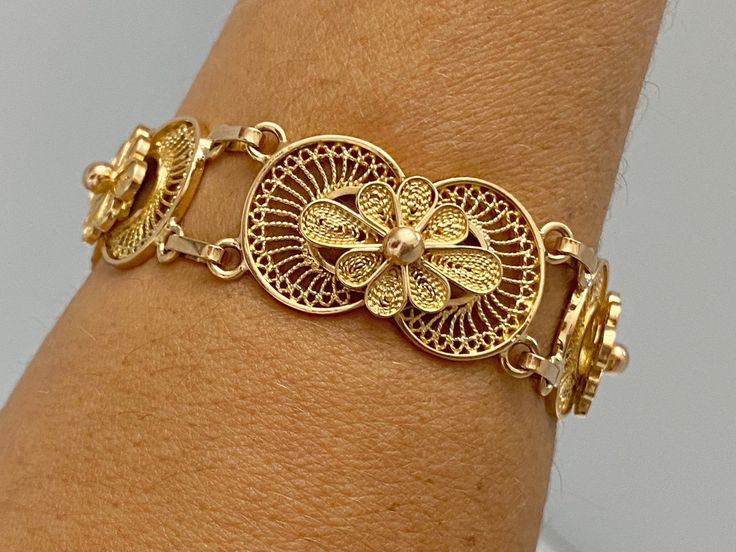 "Pacific Jewelry Key West Presents, Vintage Filigree bracelet, circa 1960's. Beautiful and intrinsic lace design, super feminine and just beautiful to look at. This bracelet is a true testament to fine craftsmanship with pliable threats and curls in 14K Yellow gold. ✔ Antique filigree bracelet ✔ Gold Karat: 14K ✔ Authentic art deco metalwork ✔ Chain attached at closure for added safety. ✔ Circa 1960's ✔ Hypoallergenic ✔ Intrinsic lace design ✔ 7.0 inches long ✔ Closure: Hinged Clip **Please mess Vintage Gold Bracelet With Intricate Design For Formal Events, Vintage Gold Bracelet With Intricate Design For Formal Occasions, Ornate Yellow Gold Bracelet Jewelry, Traditional Yellow Gold Filigree Bracelets, Elegant Handmade Gold Bracelet For Ceremonial Occasions, Vintage Gold Bracelets With Intricate Design, Elegant Filigree Bracelet Jewelry, Antique Yellow Gold Bracelet For Wedding, Ceremonial Filigree Bracelet Jewelry