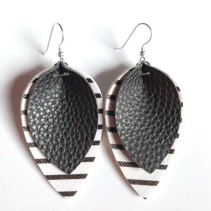 Add a pop of drama to your look with our Black Striped Leather Drop Earrings. The unique combination of materials and trendy design create a playful and stylish look, perfect for any fashion-forward individual. Measures 2.25” Handmade Black Casual Earrings, Handmade Casual Black Earrings, Black Faux Leather Trendy Jewelry, Chic Handmade Black Earrings, Black Faux Leather Jewelry As Fashion Accessory, Trendy Black Faux Leather Jewelry, Trendy Black Everyday Earrings, Trendy Faux Leather Earrings As Gift, Black Leather Drop Earrings