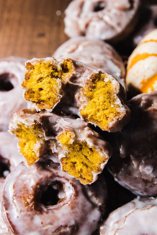 a pile of doughnuts sitting on top of a wooden table