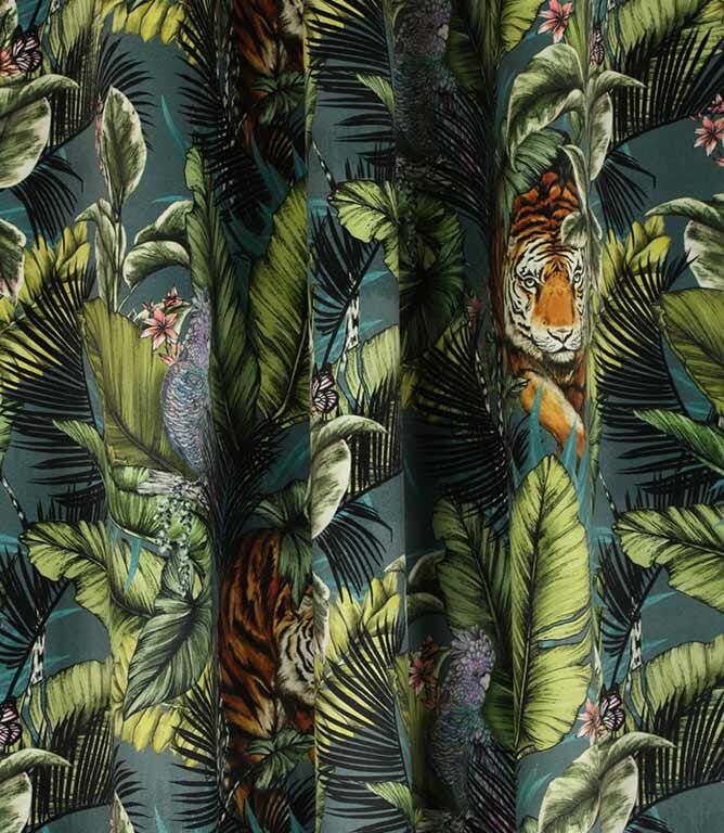 a tiger and flower print curtain with green leaves on the outside, in front of a blue background