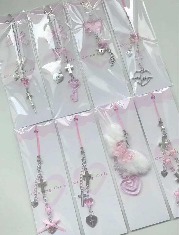 a bunch of pink and white necklaces in plastic bags