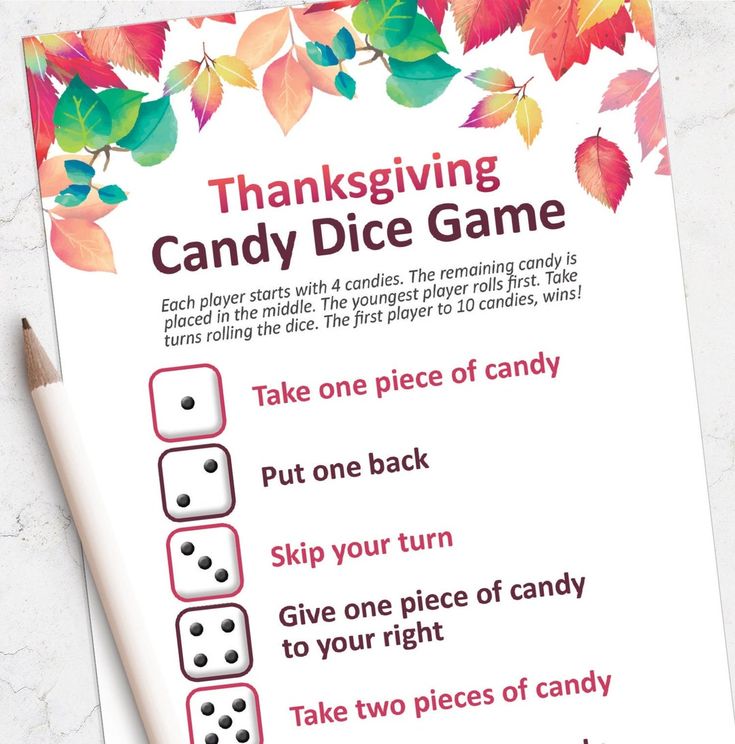 a thanksgiving candy dice game is shown on a table with a pencil and paper next to it