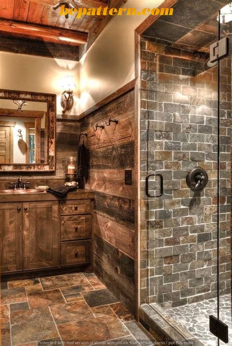 a rustic bathroom with stone walls and flooring is shown in this image, there is a walk - in shower that has glass doors on both sides