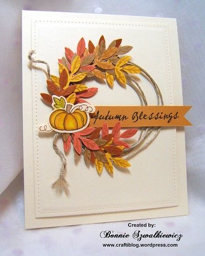 a handmade card with autumn greetings written on the front, and an orange ribbon around it