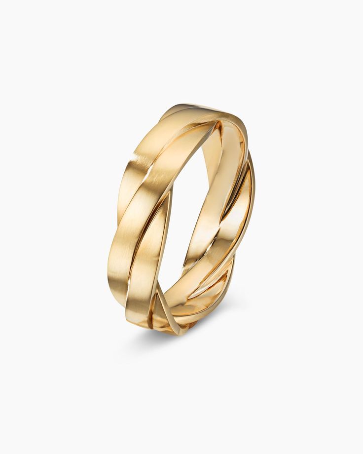 a gold ring that is shaped like an interlocked knot, on a white background