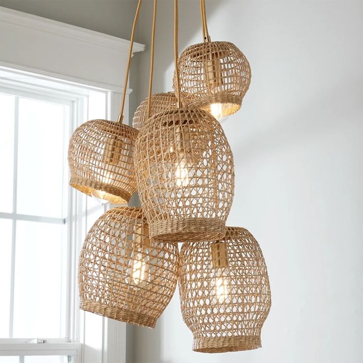 a chandelier made out of woven material hanging from the ceiling next to a window