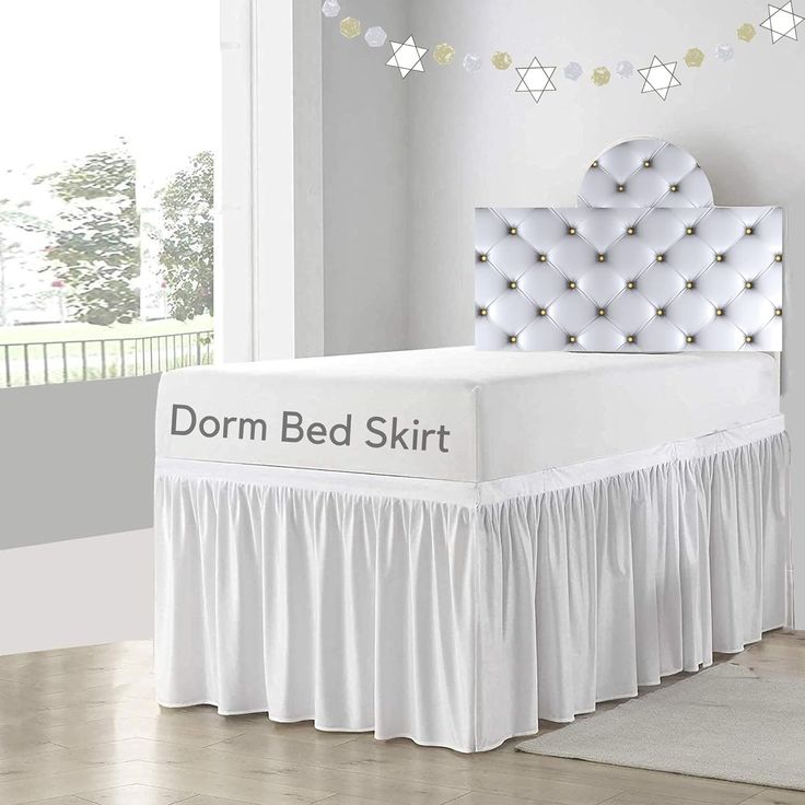 the bed skirt is white and has gold stars on it