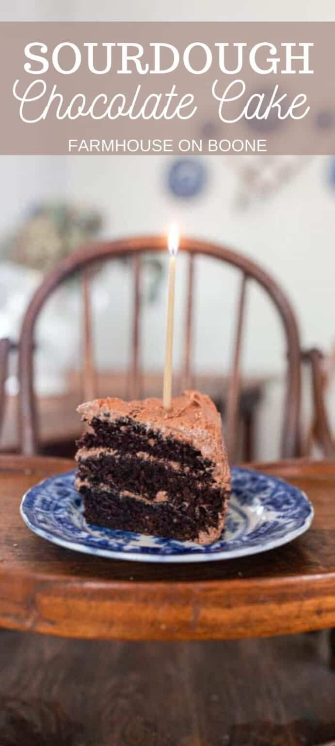 a piece of chocolate cake on a plate with a lit candle in the middle that says, sourdough chocolate cake farmhouse on bone