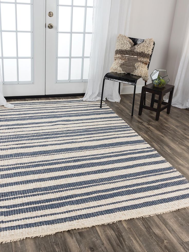 a white and blue striped rug in front of a door