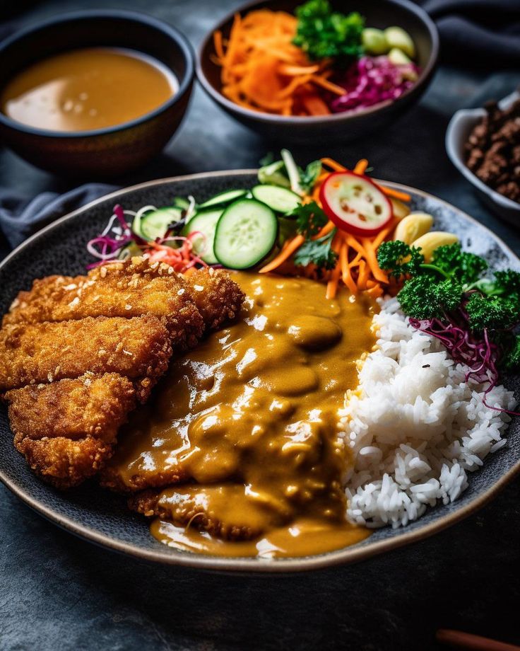 a plate with rice, meat and veggies next to bowls of sauces