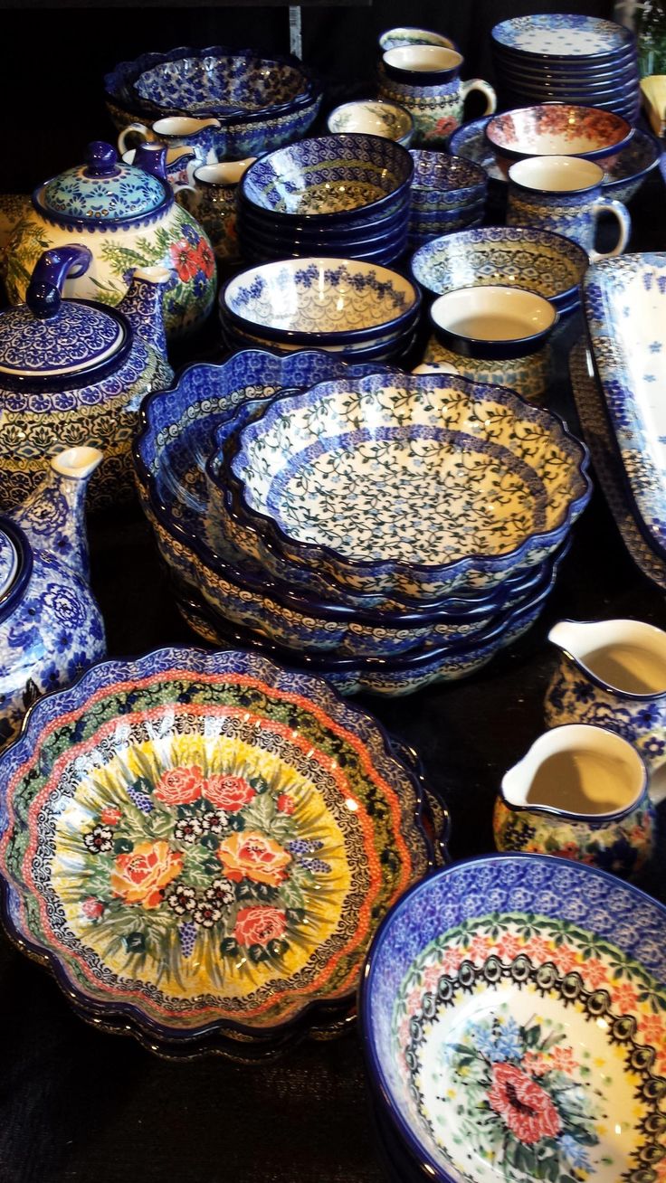 a table topped with lots of blue and white plates