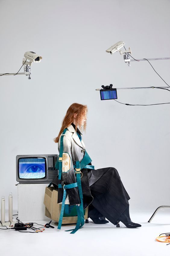 a woman sitting on top of a chair in front of a tv