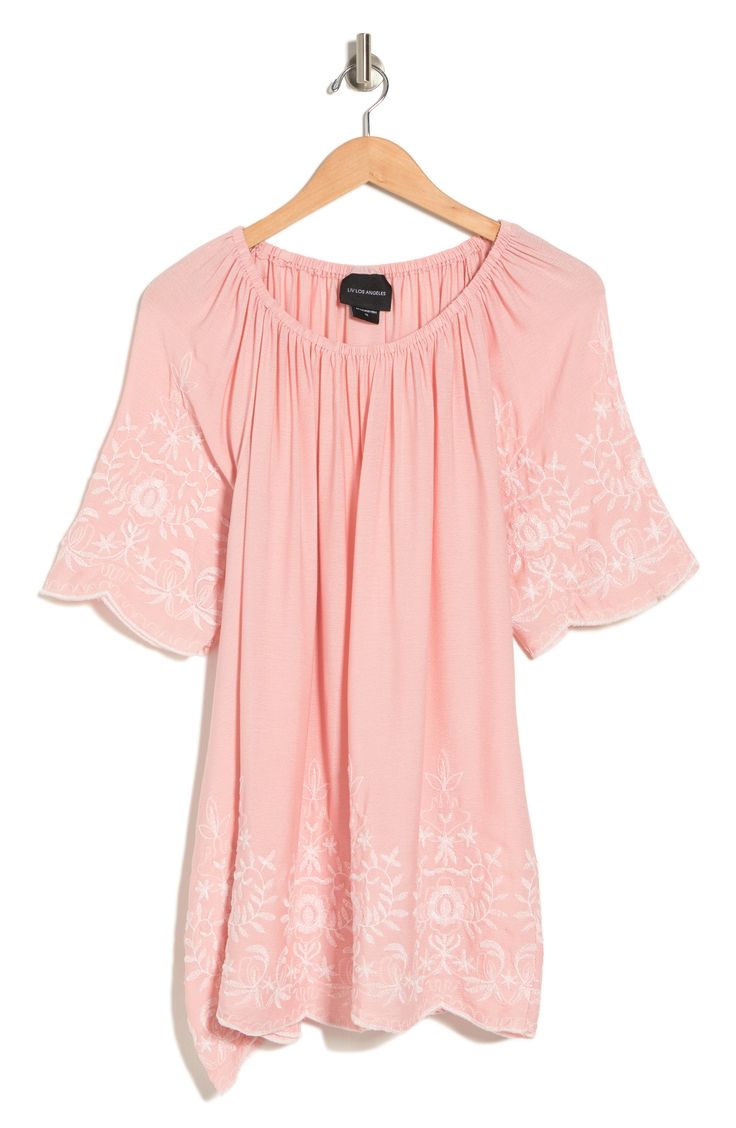 Pretty floral embroidery at the scalloped trim lends playful boho vibes to this relaxed-fit tunic top. 29" length (size 1X) Scoop neck Short sleeves 100% rayon Hand wash, line dry Imported Model stats: 5'10" height, 41" bust, 36" waist, 48" hip. Model is wearing size 1X Spring Bohemian Embroidered Tunic Top, Bohemian Spring Embroidered Tunic Top, Bohemian Rayon Top With Floral Embroidery, Bohemian Rayon Tops With Floral Embroidery, Spring Embroidered Rayon Blouse, Casual Rayon Tunic For Spring, Spring Beach Peasant Style Embroidered Top, Bohemian Peasant Top With Embroidered Neckline For Spring, Bohemian Flowy Embroidered Top With Floral Design