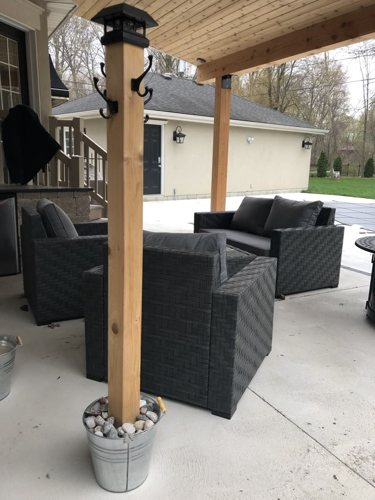 an outdoor living area with chairs and tables