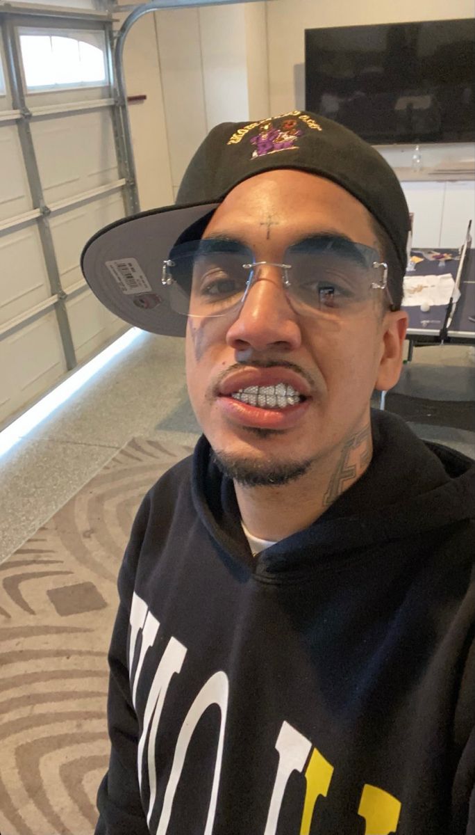 a man wearing glasses and a hat in an airport