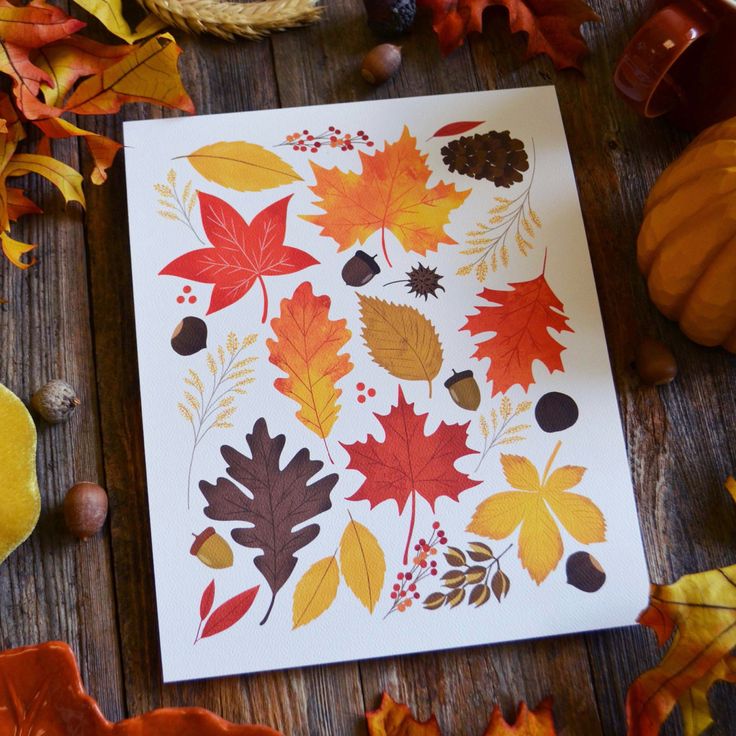 an image of fall leaves and acorns on a table with other autumn decorations