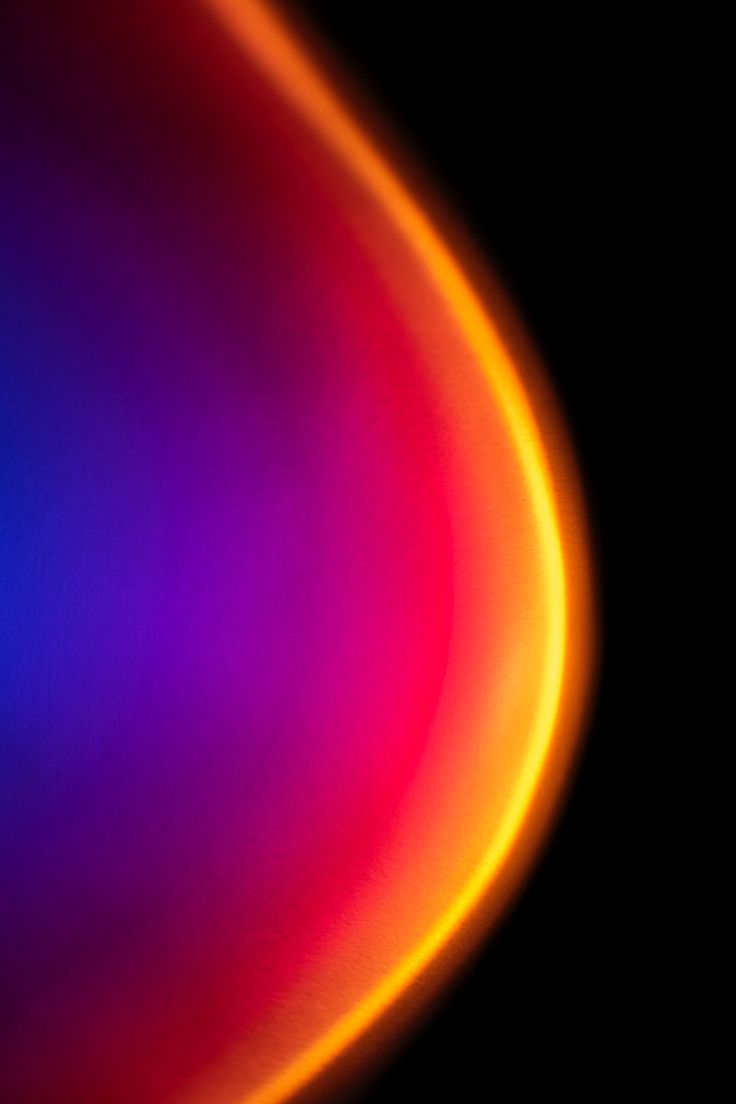 an orange and pink object is shown in the middle of this image with black background