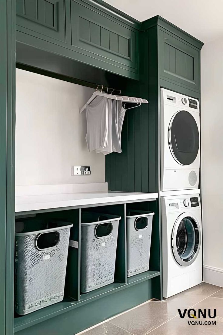 a washer and dryer in a laundry room with green cabinets, white counter tops and drawers