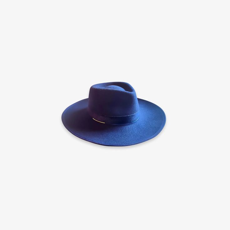 Introducing the Kate fedora hat, a timeless staple in any wardrobe. Crafted with premium wool, this semi-stiff fedora features a classic teardrop crown and an upturned medium brim. The velvet band with a gold ornament finish give this hat a modern look. The Kate is an elegant and highly versatile fashion statement. 100% wool Crown: 8 cm | 3.15" Brim: 9 cm | 3.54" Color: navy blue UPF 50+ Handmade in Ecuador Adjustable inner sweatband for added custom fit Elegant Fur Felt Panama Hat For Fall, Flat Crown Fur Felt Fedora, Formal Solid Fedora With Flat Crown, Chic Wool Fedora With Flat Brim, Chic Fedora With Flat Crown For Formal Occasions, Elegant Panama Hat With Flat Crown For Fall, Chic Formal Fedora With Flat Crown, Modern Wide Brim Hat For Formal Occasions, Chic Fur Felt Fedora With Short Brim