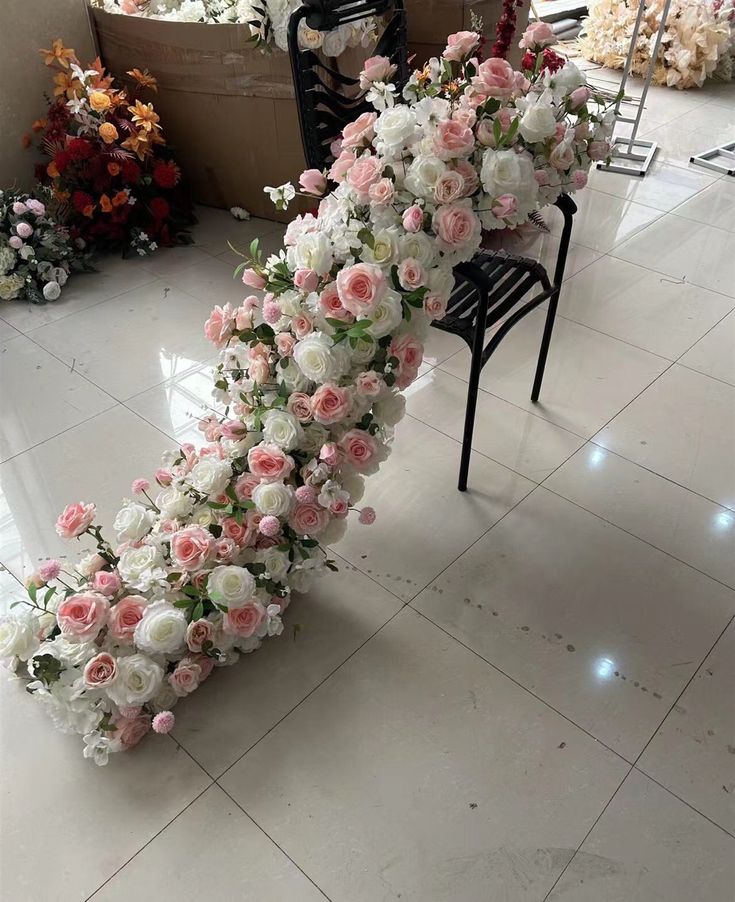 a bunch of flowers that are laying on the ground in front of a chair and table