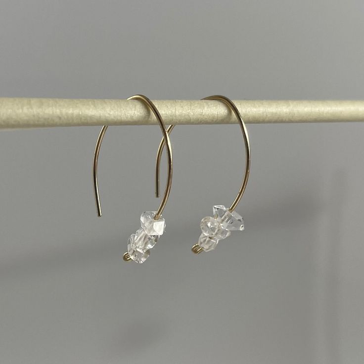 Hand formed round shaped ear wires hold three small Herkimer diamonds* each. Simple, delicate and timeless with a hint of sparkle. *Please note that Herkimer diamonds are not actual diamonds. They are double-terminated clear quartz that are given that name due to their clarity and natural faceting - there are 18 faces total on each stone. They can only be found in the United States. Elegant Clear Crystal Earrings For Everyday, Elegant Clear Hoop Earrings, Minimalist Diamond Earrings With Ear Wire, Alexis Bittar Earrings, Cold As Ice, Handmade Jewelry Diy, Alexis Bittar, Herkimer Diamond, Wire Earrings