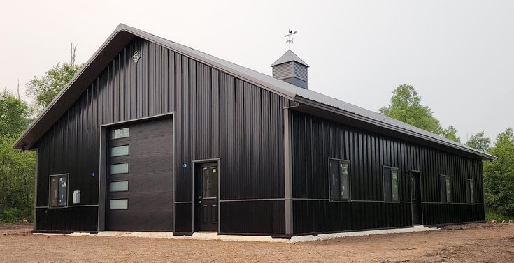 a black building with two doors and a steeple