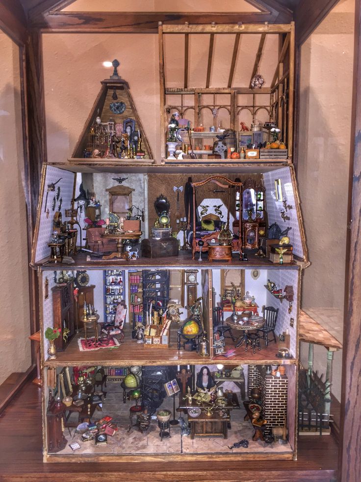 a doll house with lots of furniture and accessories in it's display case on top of a wooden floor