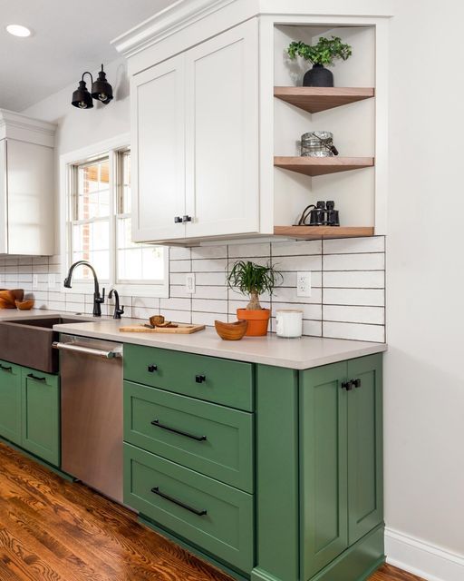 a kitchen with white and green cabinets, stainless steel sink and dishwasher in the center