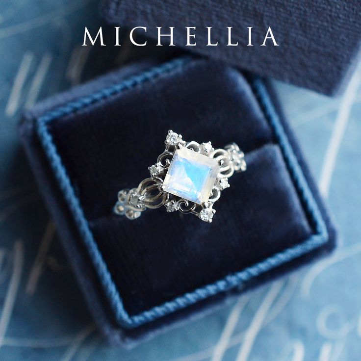 "Our current turnaround time for regular orders is 6-8 weeks. For urgent orders, please shop our Ready-to-Ship collection below (7-10 business days): https://michellia.com/collections/ready-to-ship (please copy and paste into browser) -------- 「Elsa」- Vintage Princess Square Ring, in Rainbow Moonstone | R1005 Inspired by the legendary Queen of Arendelle, this regally luxurious design features an ice-like center stone marked by its unmistakable brilliance. The vintage-inspired filigree details su Ethereal Jewelry With Rose Cut Diamonds And Moonstone, Ethereal Moonstone Jewelry With Rose Cut Diamonds, Celestial 14k Gold Opal Wedding Ring, Ethereal Moonstone Wedding Ring With Rose Cut Diamonds, Heirloom White Moonstone Ring With Rose Cut Diamonds, Ethereal Moonstone Ring For Anniversary, Delicate White Moonstone Ring, Delicate White Moonstone Gemstone Ring, Celestial Style Moonstone Wedding Ring In 14k Gold