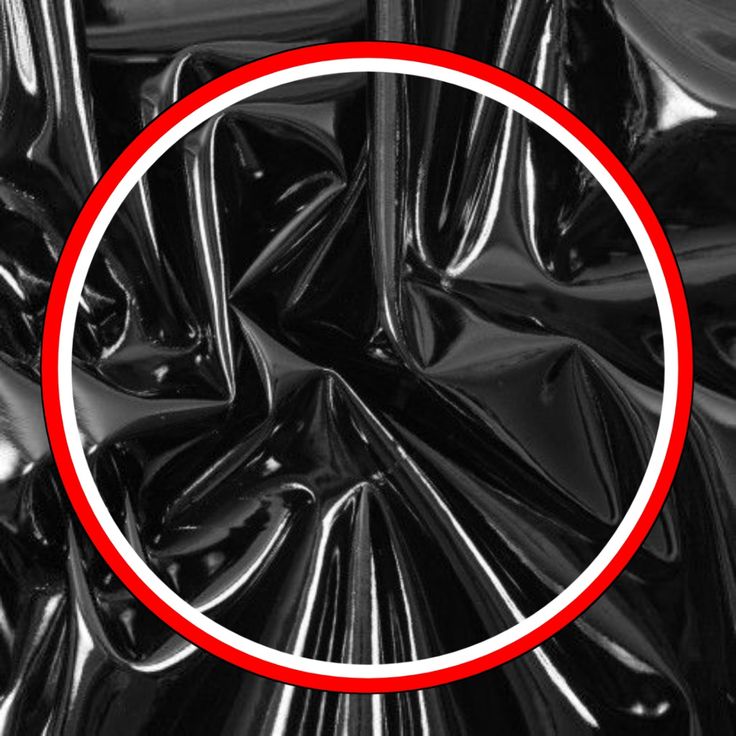 a red circle is in the middle of black shiny material, with white lines running through it