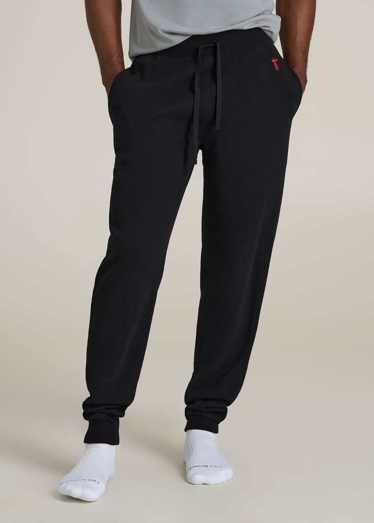 Upgrade Your Loungewear Game Tall Men's Jogger Pants That Fit Just Right Take your loungewear to the next level with our Waffle-Knit Lounge Jogger for tall men. These extra-long men's joggers offer a regular fit with a mid-rise that sits comfortably, and the drawstring waist ensures a secure fit. Side seam pockets add practicality to this essential home wear piece. Perfect for relaxing at home or running errands, these tall joggers combine comfort and functionality tailored for your taller frame Black Relaxed Fit Sweatpants For Relaxation, Comfortable Black Stretch Pants, Black Cotton Joggers For Lounging, Black Cotton Bottoms For Relaxation, Black Pants With Comfort Waistband For Loungewear, Black Bottoms With Comfort Waistband For Lounging, Black Lounging Bottoms With Comfort Waistband, Black Comfort Stretch Full Length Sweatpants, Comfortable Black Activewear For Relaxation