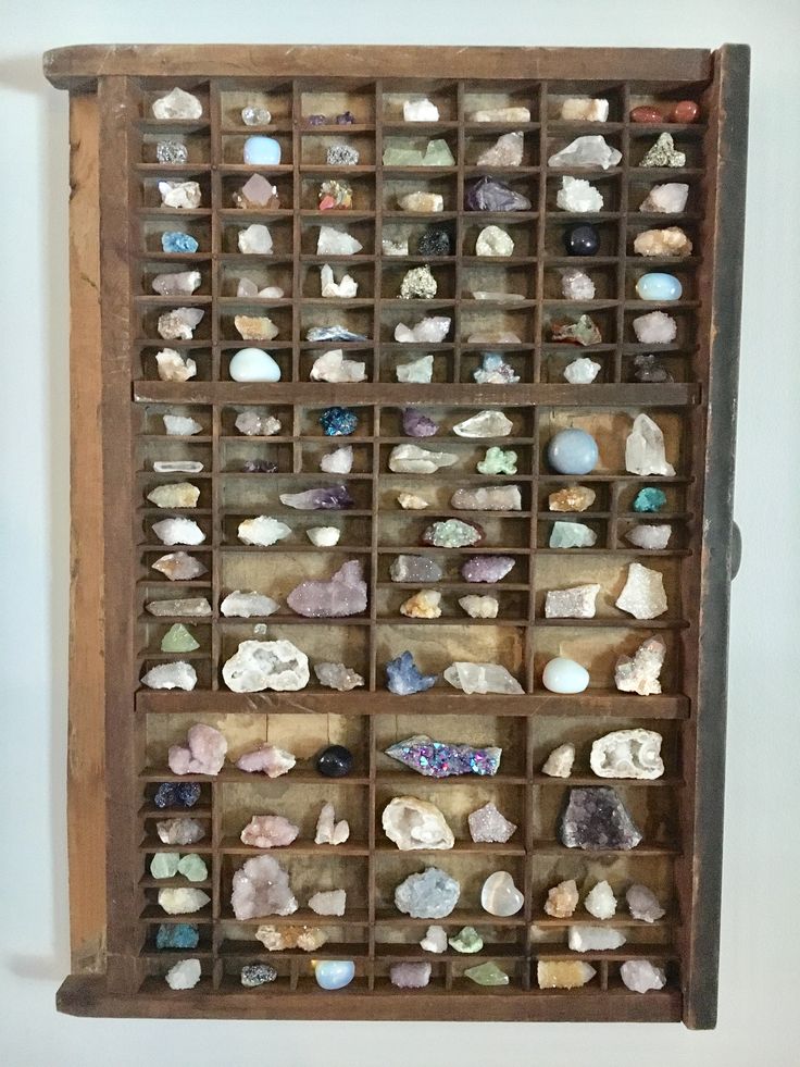 a wooden box filled with lots of different types of rocks and stones on it's sides