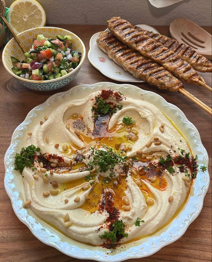 a table topped with plates and bowls filled with different types of food on top of it