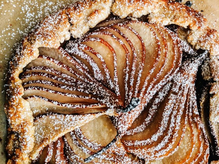 an apple pie with powdered sugar on top