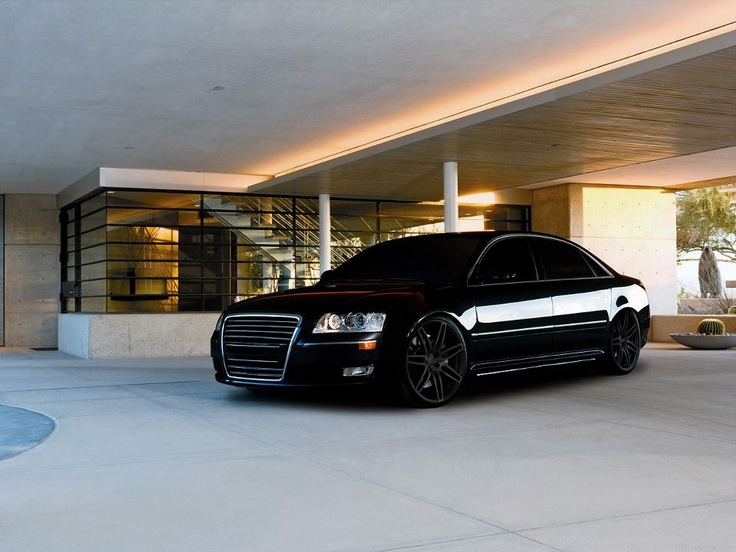 a black car parked in front of a building