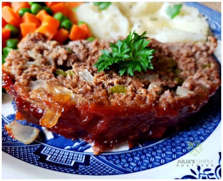 meatloaf with mashed potatoes, carrots and parsley on a blue plate