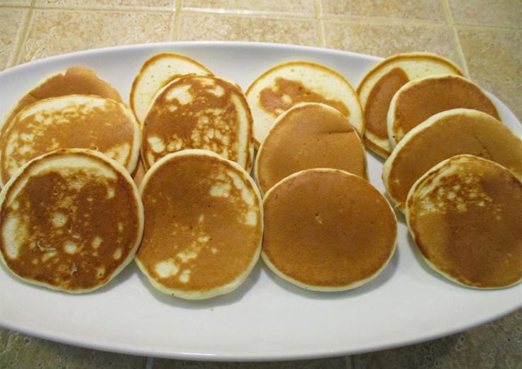 a white plate topped with lots of pancakes