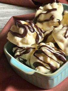 a bowl filled with ice cream covered in chocolate