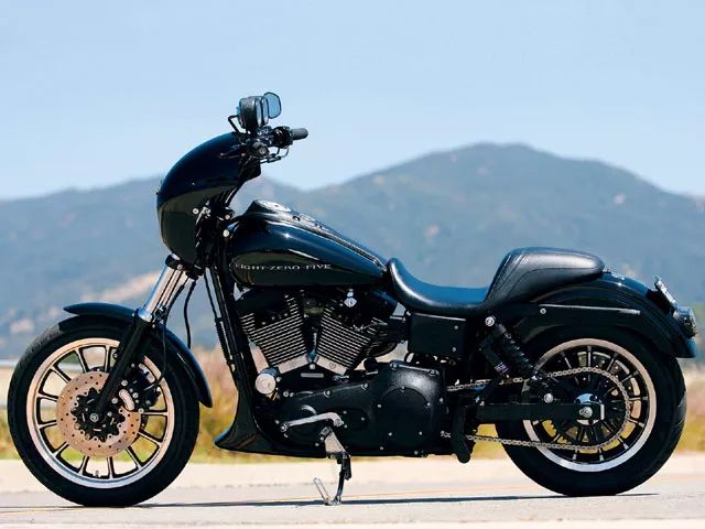 a black motorcycle parked on top of a road