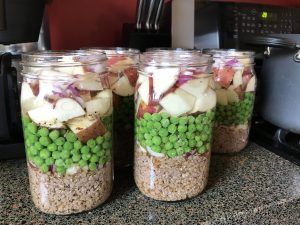 three jars filled with food sitting on top of a counter