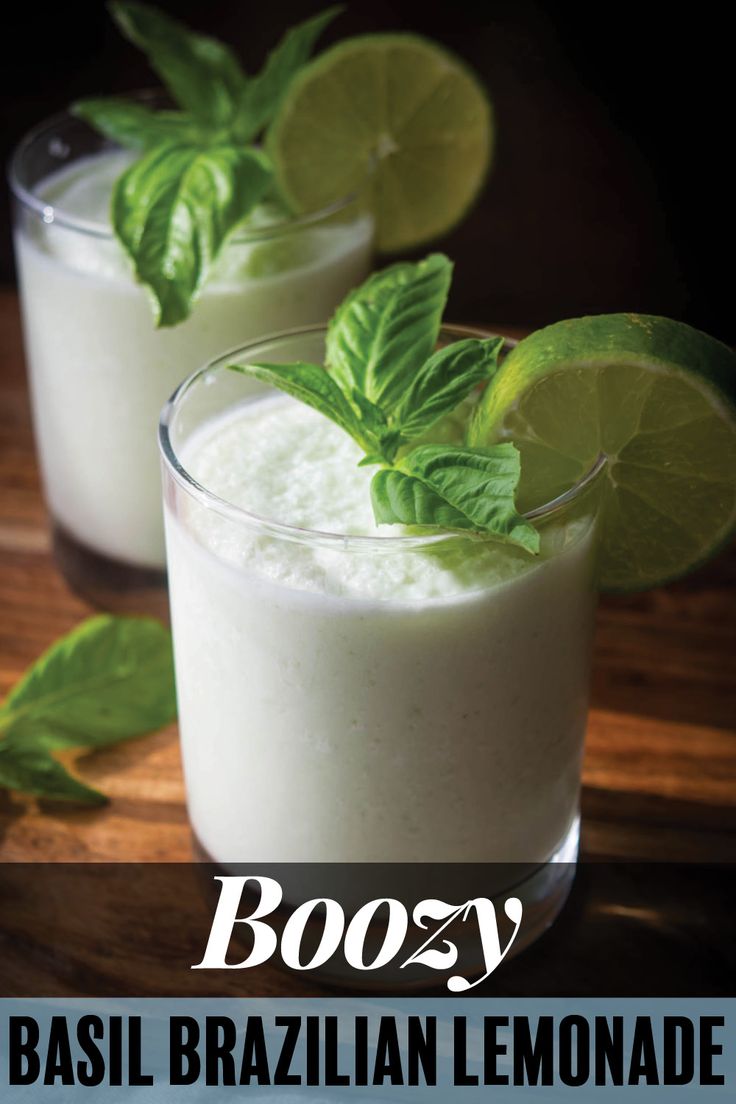 two glasses filled with boozy and garnished with mint