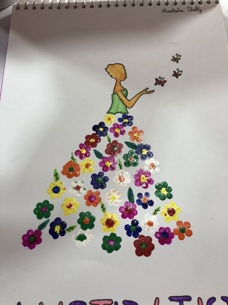 a child's drawing of a girl in a dress with flowers on it