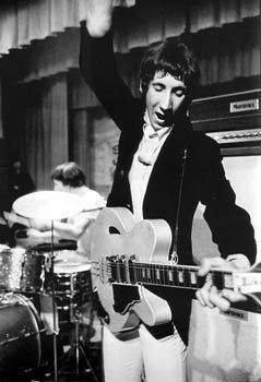 the rolling stones performing on stage with their guitars