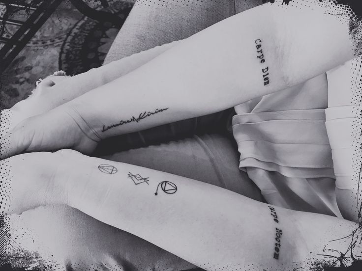 black and white photograph of two legs with tattoos on them, one has the word love written