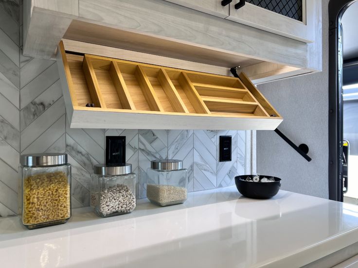 the kitchen counter is clean and ready to be used as a storage compartment for spices