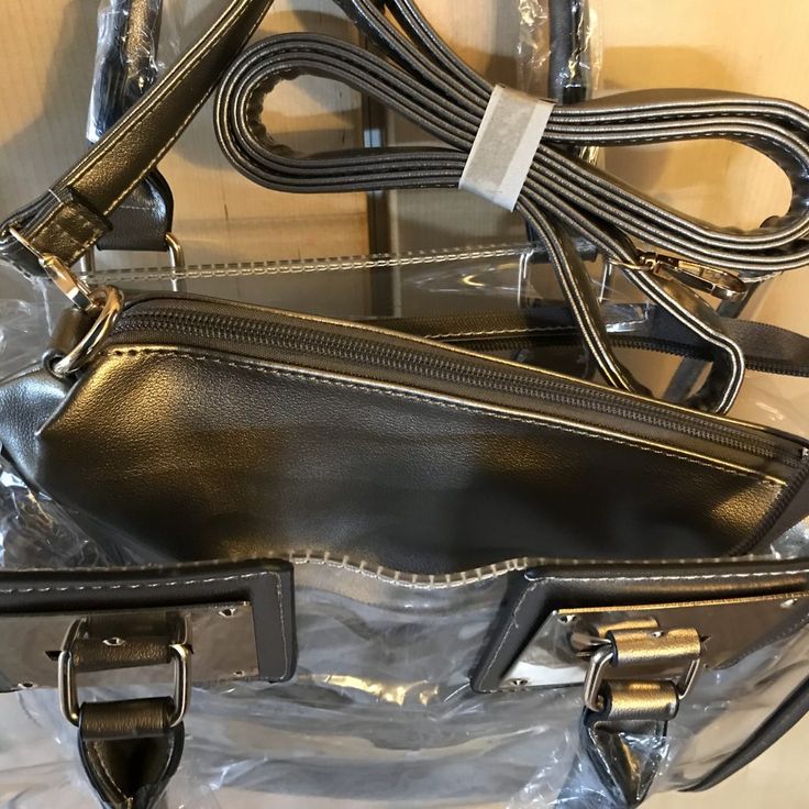 This satchel and tote handbag is 2-in-1. It's a transparent satchel tote with a complimentary removable shoulder bag. This bag is awesome! If you love chic bags, this is the perfect bag for you!

2-day processing. Shipped in 4-7 days. Trendy Bags With Clear Strap And Top Handle, Trendy Top Handle Shoulder Bag With Clear Strap, Trendy Top Handle Bag With Clear Strap, Everyday Satchel With Clear Strap And Crossbody Shape, Everyday Satchel With Clear Crossbody Strap, Clear Crossbody Shoulder Bag With Zipper Closure, Clear Crossbody Shoulder Bag With Zipper, Clear Strap Shoulder Bag Satchel For Shopping, Daily Use Top Handle Shoulder Bag With Clear Strap