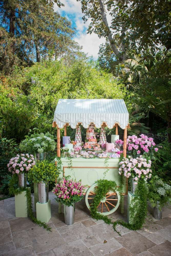 an old fashioned ice cream cart decorated with flowers